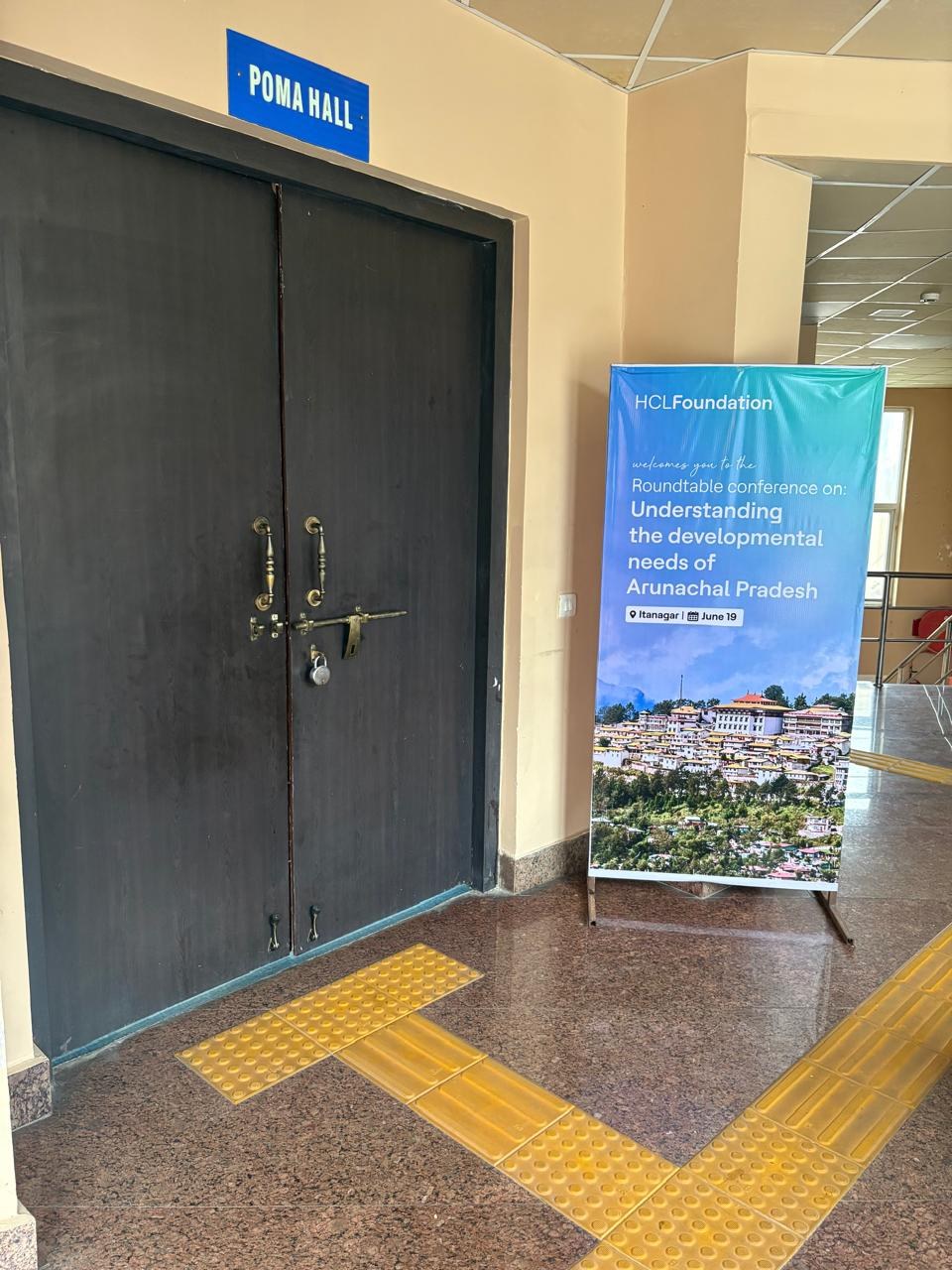 HCLFoundation roundtable event standee near the venue entrance